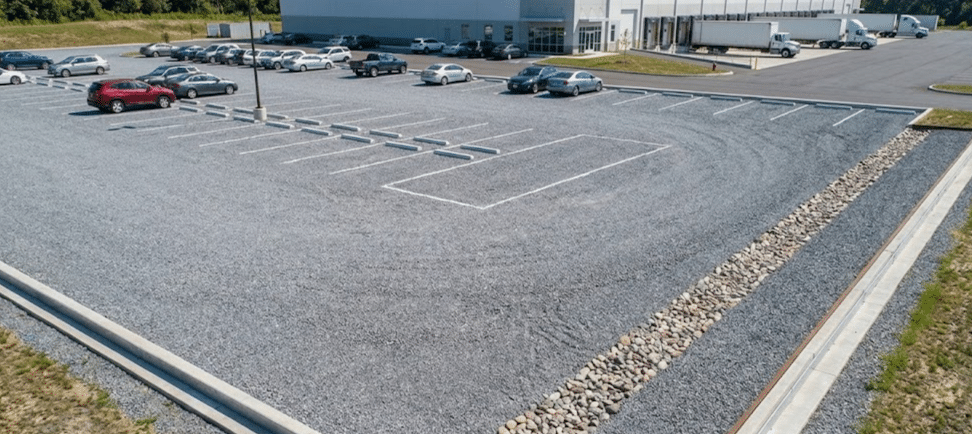 Commercial gravel parking lot with visible crushed stone surface and marked parking spaces