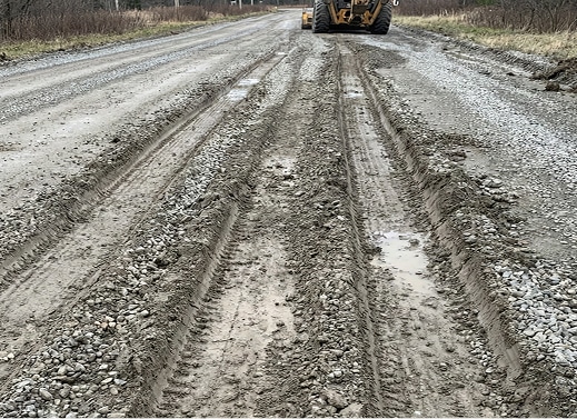 Gravel ruts, migrates, and disappears into soft subgrade